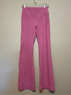 Fabletics Pink Flared Leggings with Side Pockets criss cross waist